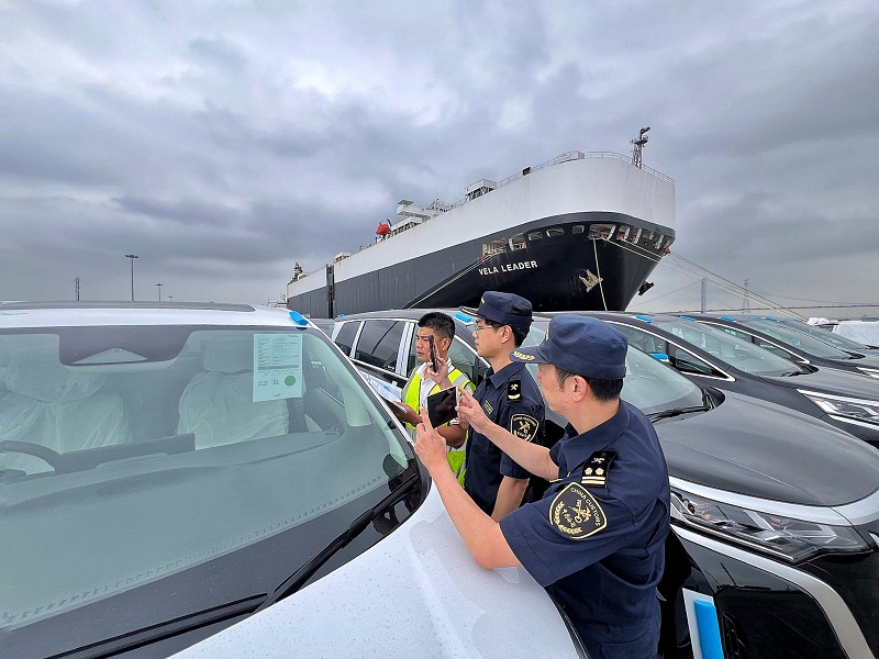 China customs officers inspecting export vehicles